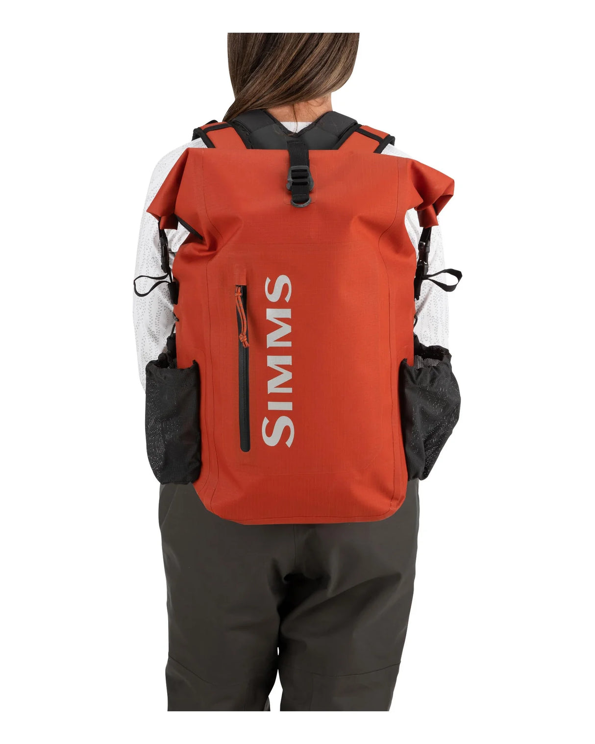Person wearing a red backpack with 'Simms' branding on a white background