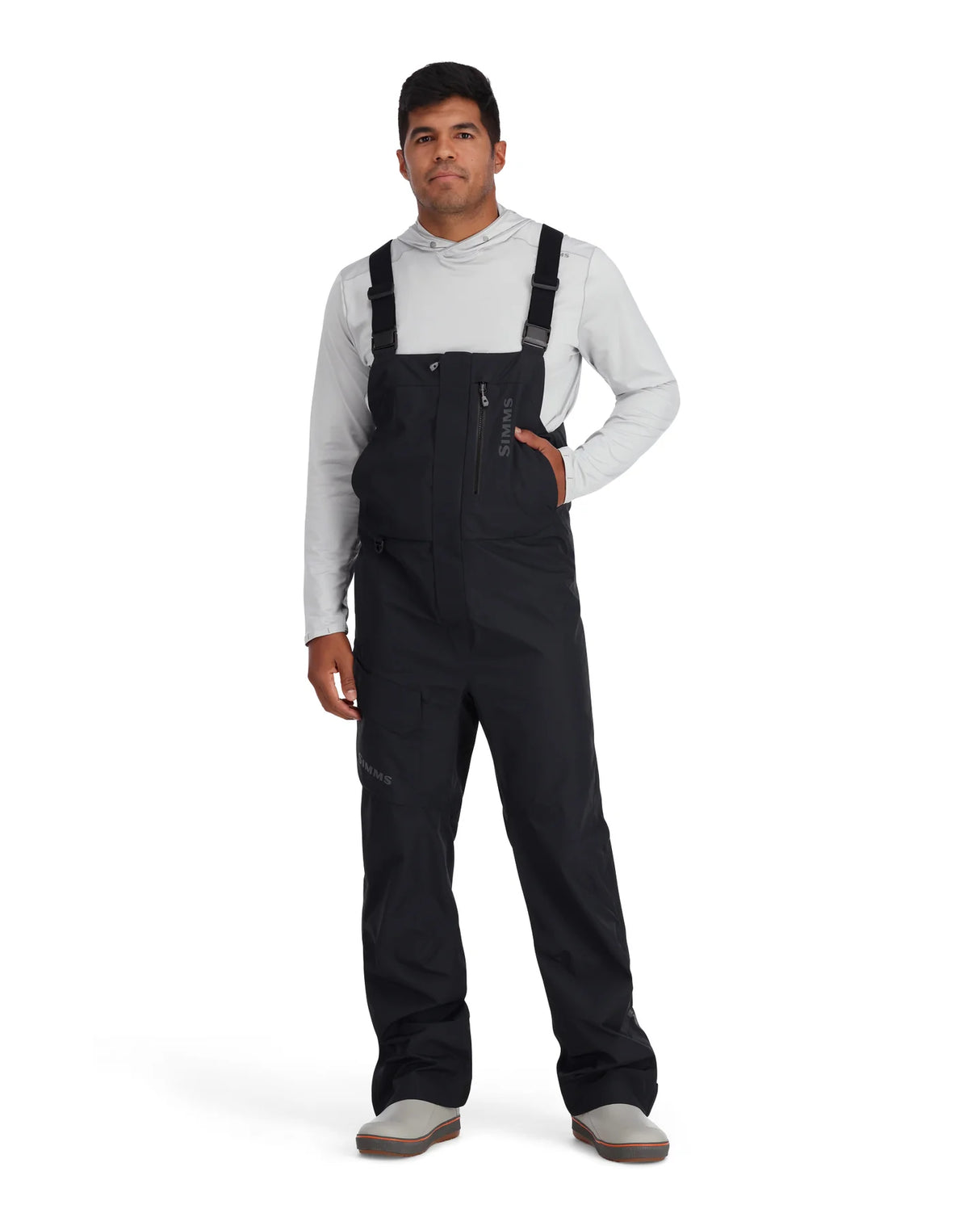 Man wearing black bib overalls on a white background
