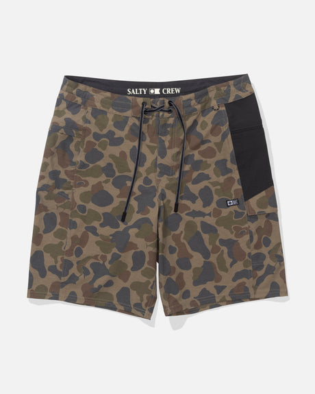 The Salty Crew Flagship 20" Boatshort in Sand Camo features green and brown camouflage, a black waistband and side pocket, drawstring closure, SALTY CREW branding, quick-dry ripstop fabric, and a durable front patch.