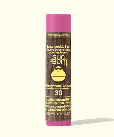 Sun Bum sunscreen lip balm with pink cap and brown body on a white background
