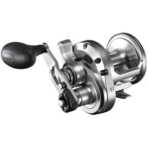 Conventional saltwater fishing reel with power handle, silver finish