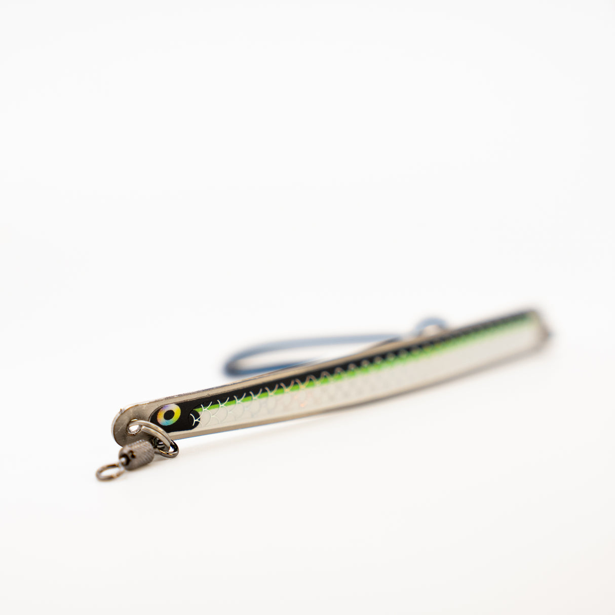 Metallic fishing lure with a green accent on a white background