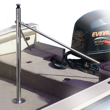 Boat with a stainless steel bumper and Evinrude outboard motor on a concrete surface.