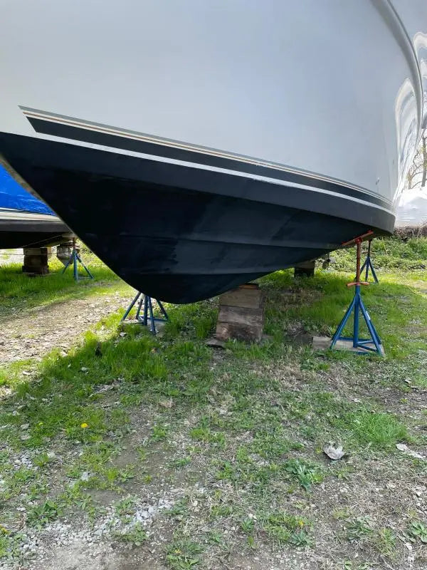 Boat hull with black antifouling paint applied, showing Bottomkote CA finish on bottom