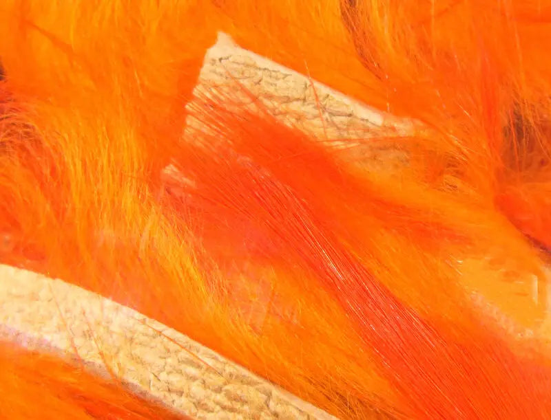 Close-up of bright orange fabric with visible texture