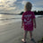 Child wearing a pink t-shirt with 'Harbour Chandler' branding on a beach. - Pink - XS