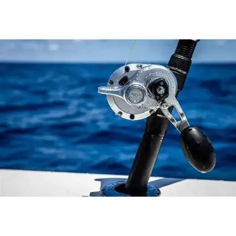 Saltwater fishing reel mounted on rod over ocean water