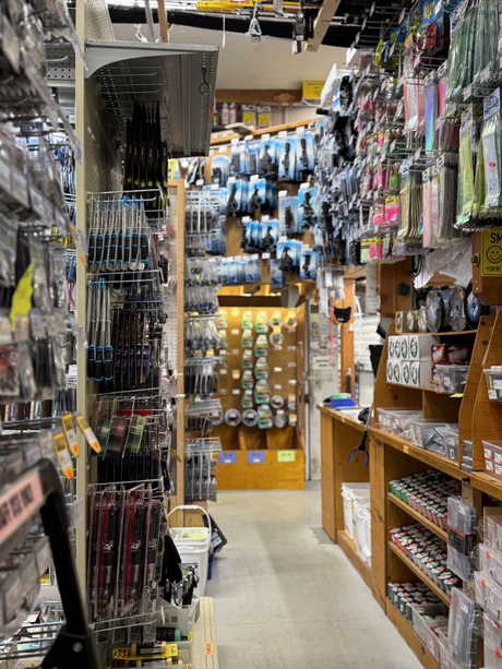 Tire store aisle with shelves stocked with various products