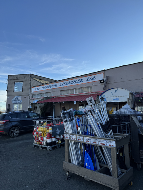 Storefront with 'The Hamber Chandler Ltd.' sign, outdoor display of items including oars.