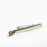 Metallic fishing lure with a green accent on a white background