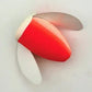 Red and white mushroom-shaped object on a light gray background