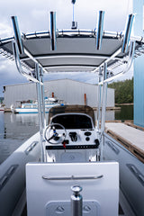 Looking forward past the seat and helm to the T-top with four rod holders, at the dock