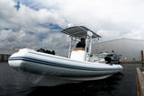 AB Inflatables 21 Oceanus VST rigid inflatable boat on the water beside a dock, under a cloudy sky