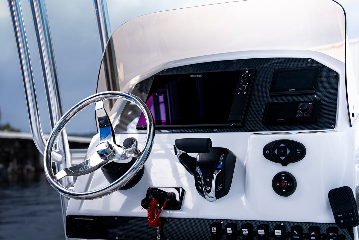 Helm close-up: stainless steering wheel, Yamaha digital throttle, Simrad display and switch panel
