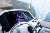 Simrad multifunction display and switch panel at the helm, behind the steering wheel