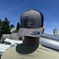 Person wearing a cap with branding against a blue sky
