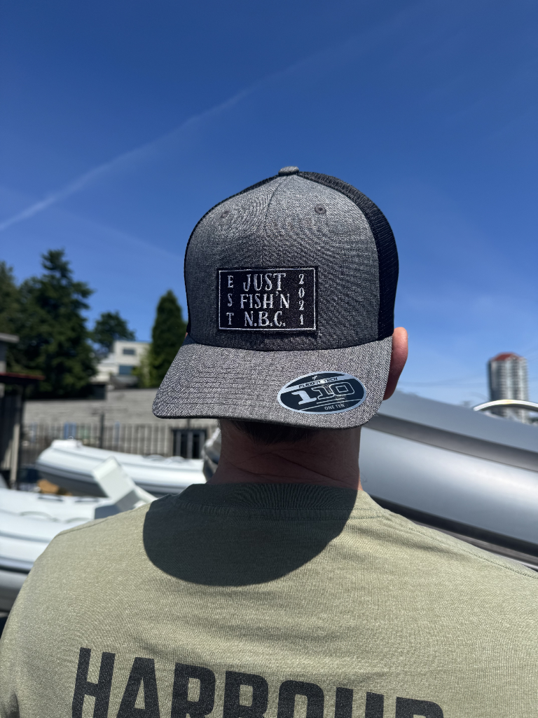 Person wearing a cap with branding against a blue sky