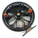 Black and orange fishing reel on a white background