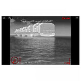 A grayscale screenshot showing a large container ship on water with overlaid tracking interface elements and the text 'Tracking AIS target HUNGARY' and a visible FLIR logo.