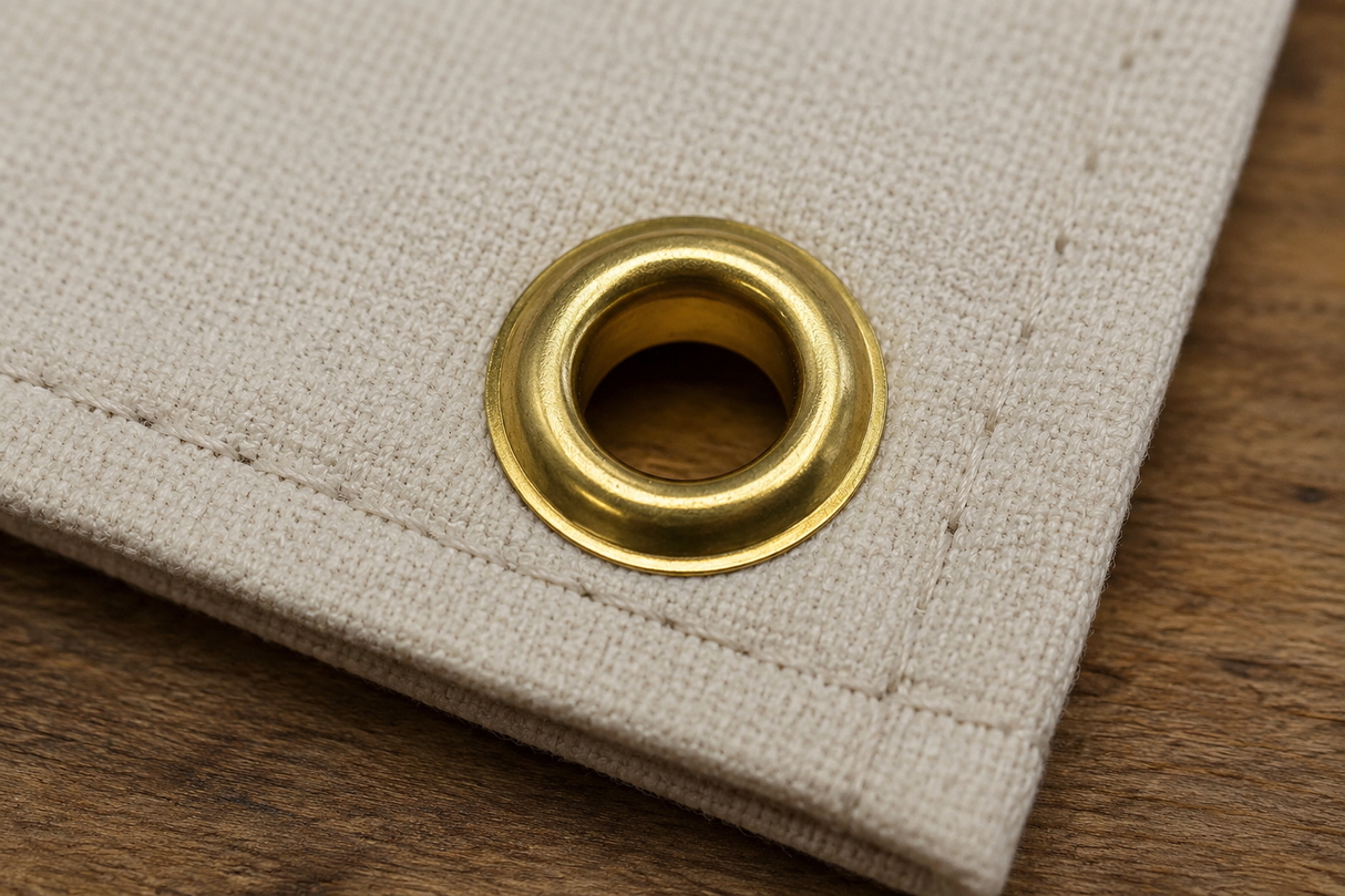 Brass rolled rim spur grommet installed in marine canvas fabric for boat covers, tarps, awnings, and outdoor applications