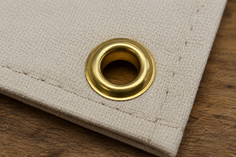 Brass rolled rim spur grommet installed in marine canvas fabric for boat covers, tarps, awnings, and outdoor applications