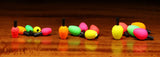 Colorful fishing bobbers on a wooden surface