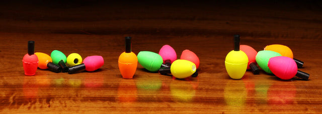Colorful fishing bobbers on a wooden surface